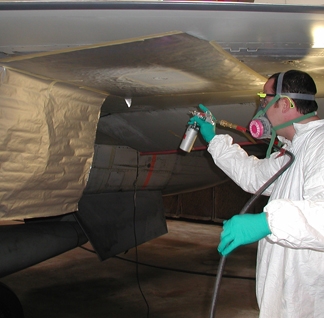 UDRI researcher primes an aircraft wing during repair