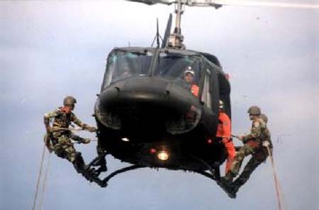 Guatemalan soldiers repelling from a helicopter