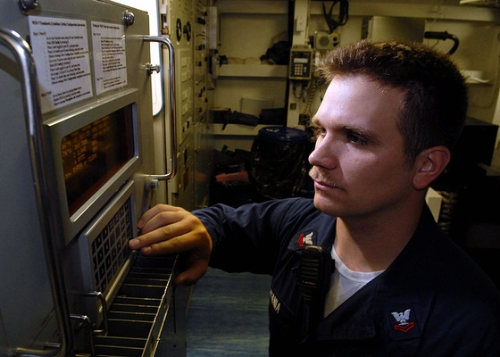 US Navy technician configures WSN-7 Navigation System .