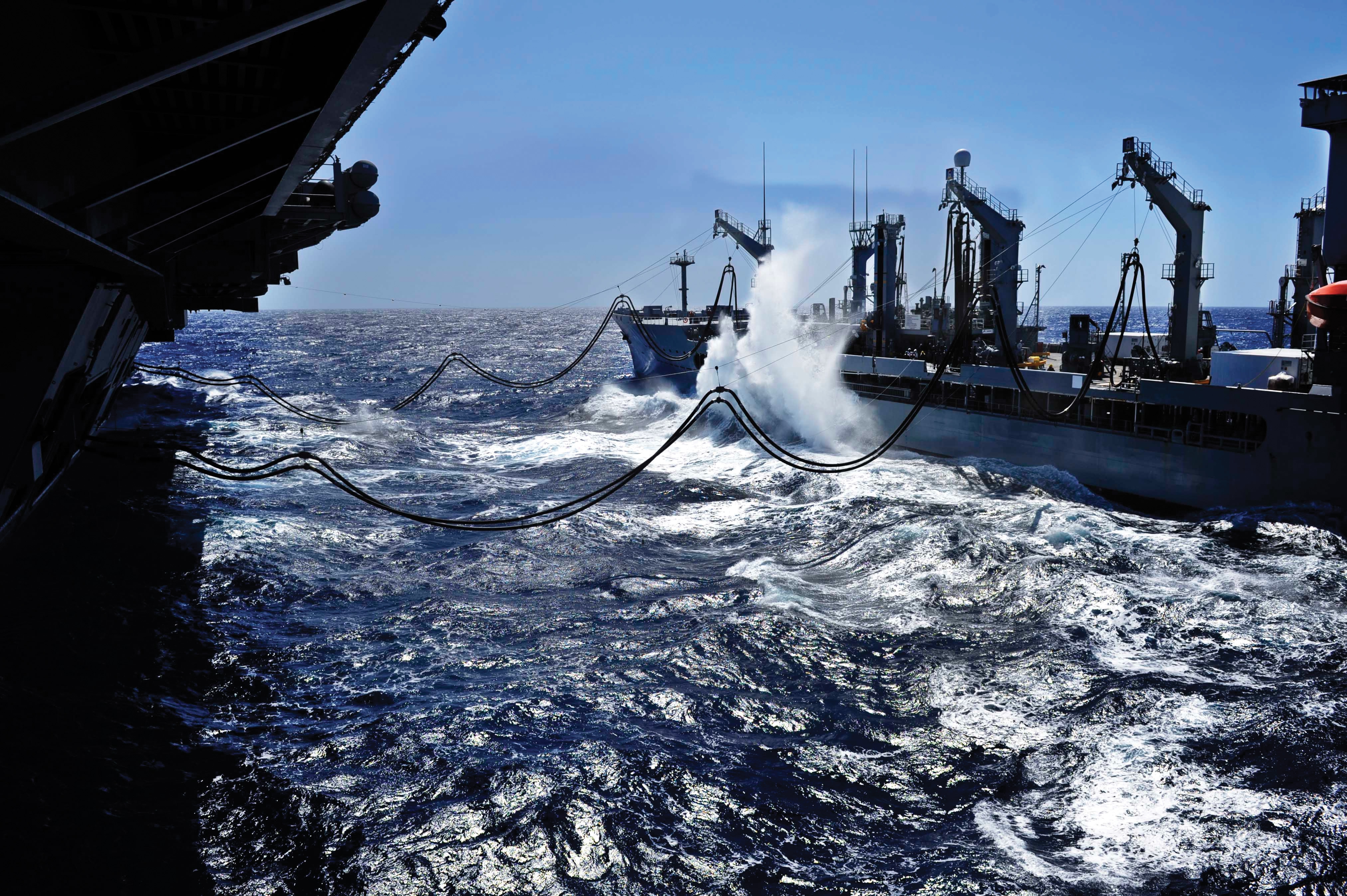 An aircraft carrier alongside a T-AO replenishment oiler