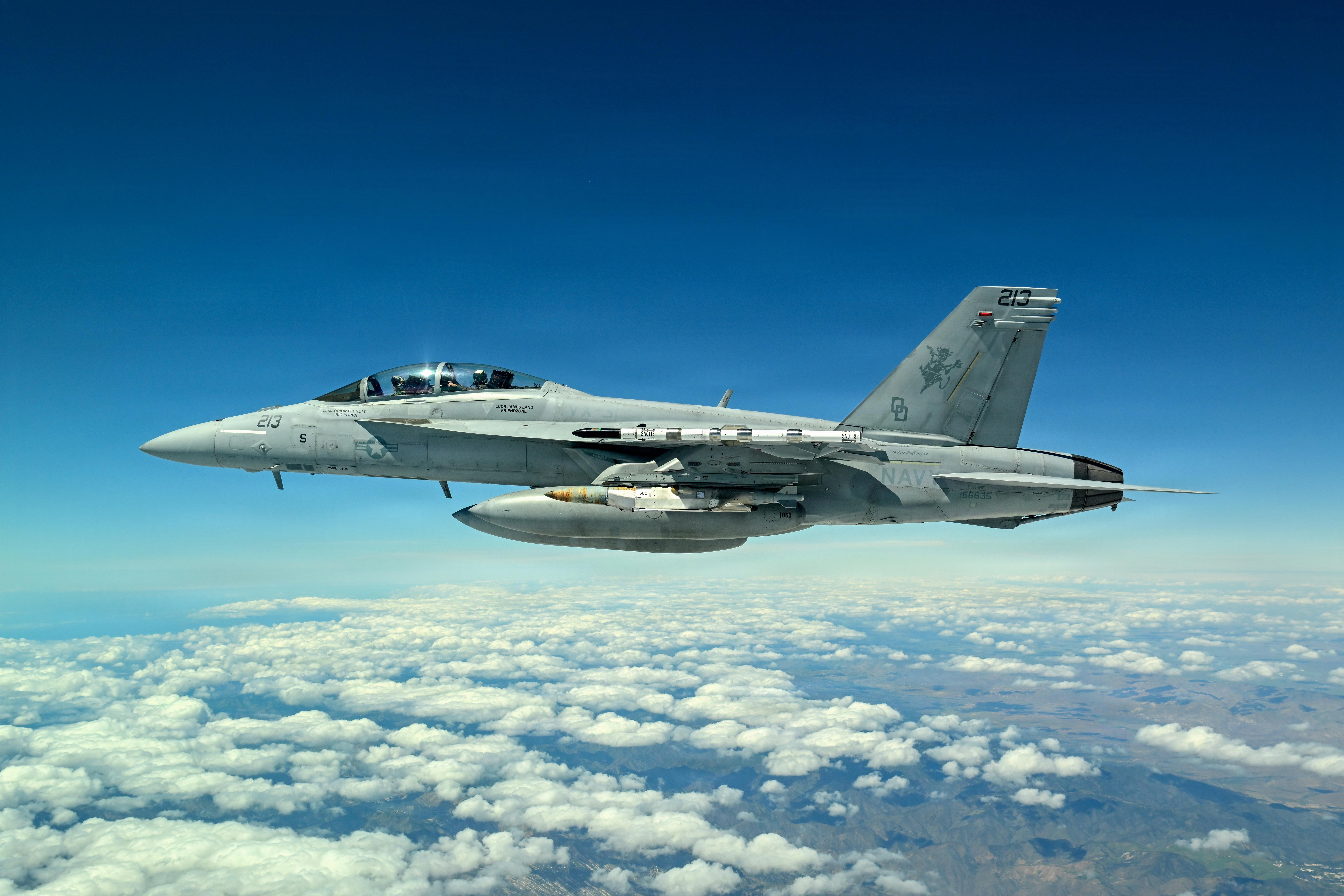 A Navy F/A-18 carries the new JDAM-LR
