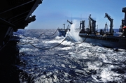 An aircraft carrier alongside a T-AO replenishment oiler