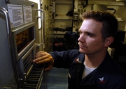 US Navy technician configures WSN-7 Navigation System .