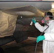 UDRI researcher primes an aircraft wing during repair